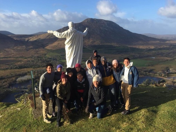 group photo with white marble statue of jesus christ at kylemore abbey